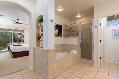 a bathroom with a tub and a bedroom with a bed at ❤PiH❤ Hono Loa BikesBeach Toys Private Beach Club in Waikoloa