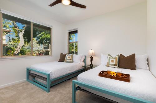 two beds in a room with two windows at ❤PiH❤ Hono Loa BikesBeach Toys Private Beach Club in Waikoloa