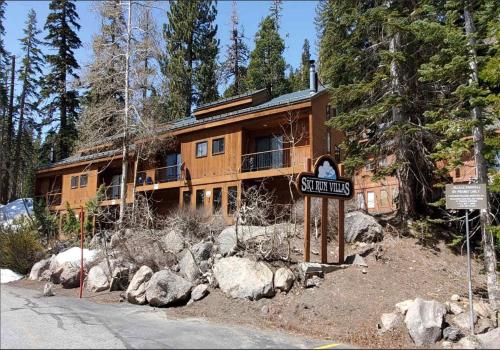 a large wooden house with a sign in front of it at Spacious 3BD & Loft Villa - Convenient to Slopes in Mammoth Lakes