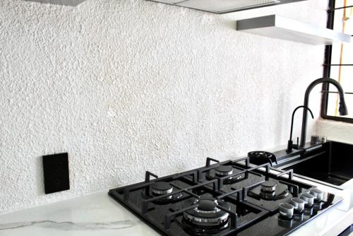 einen Herd mit Backofen in einer Küche neben einer Wand in der Unterkunft departamento plus 1917 in Zacatlán