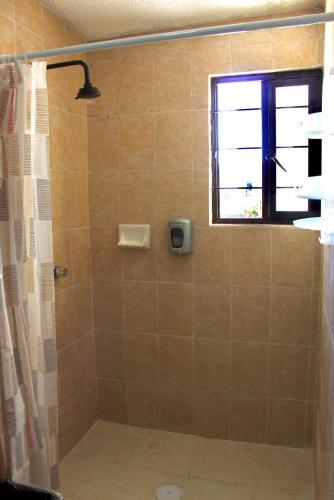 a bathroom with a shower with a window at departamento plus 1917 in Zacatlán