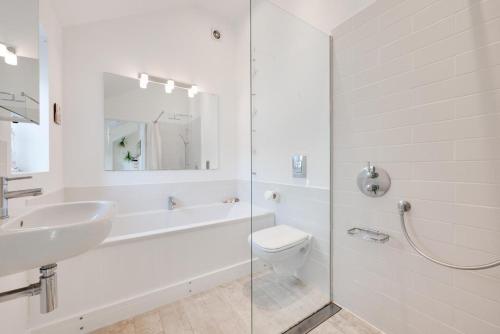 a white bathroom with a sink and a toilet at Sundial Lodge in Wilby