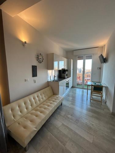 a living room with a couch and a kitchen at Stayinbologna 3 in Bologna
