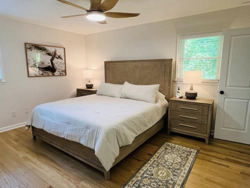a bedroom with a bed and two night stands with two lamps at The Marietta Haus in Marietta