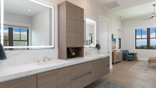 a bathroom with two sinks and a large mirror at HOKU LANI HOUSE Heated Private Pool Spa Intro Pricing 25% off in Waimea