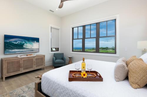 a bedroom with a white bed with a tray on it at HOKU LANI HOUSE Heated Private Pool Spa Intro Pricing 25% off in Waimea