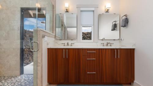 a bathroom with a sink and a mirror at ADVENTURE AWAITS Fun 4BR Ainamalu Home with Private Pool in Waikoloa