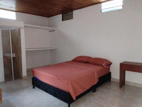 a bedroom with a bed and a glass shower at Casa Zona Rosa in La Dorada