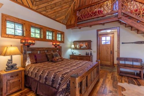 a bedroom with a bed and a wooden ceiling at River Sound Cabin at Eagles Nest in Banner Elk