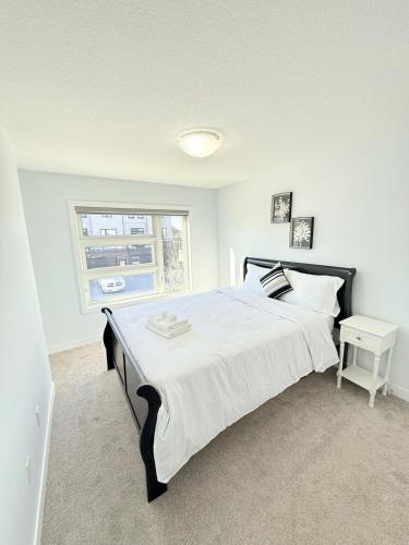 a bedroom with a large bed and a window at Charming Stay in London in London