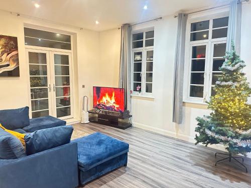 a living room with a fireplace and a christmas tree at Nottingham City Centre 3 Bed Luxury Apartment in Nottingham