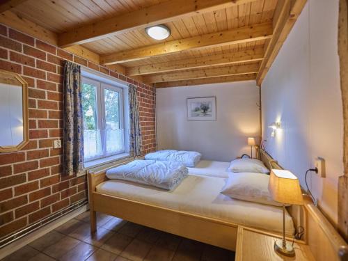 a bedroom with a bed in a brick wall at Erve Koeleman in Neede