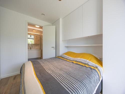 a bedroom with a bed with a yellow blanket at Apartment in Middelkerke with balcony in Middelkerke