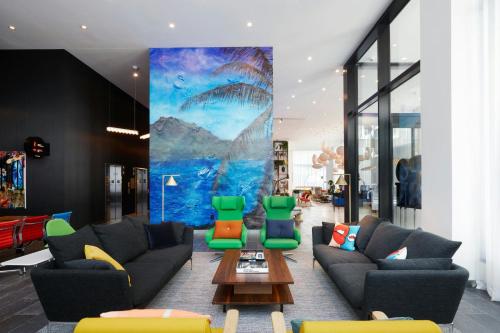 a living room with couches and a table at citizenM Los Angeles Downtown in Los Angeles