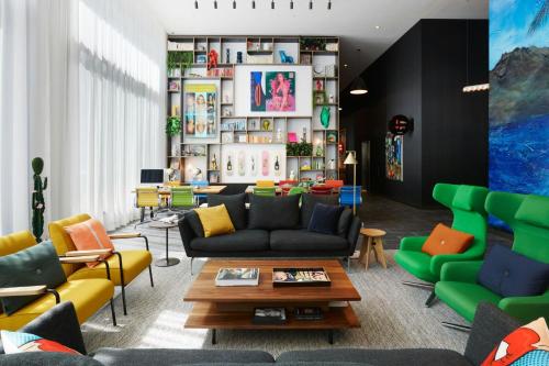 a living room with couches and chairs at citizenM Los Angeles Downtown in Los Angeles