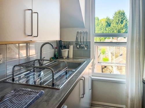 a kitchen counter with a sink and a window at Sherwood House Apartment 3 in Bakewell
