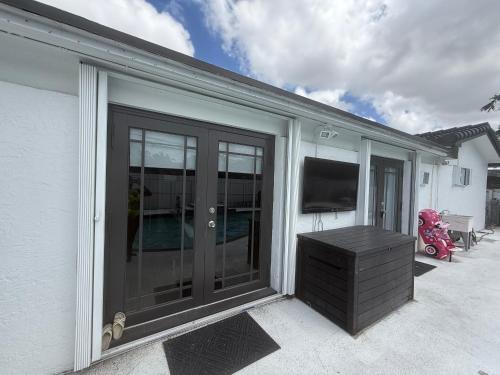 a sliding glass door with a television on a house at Room in Miami