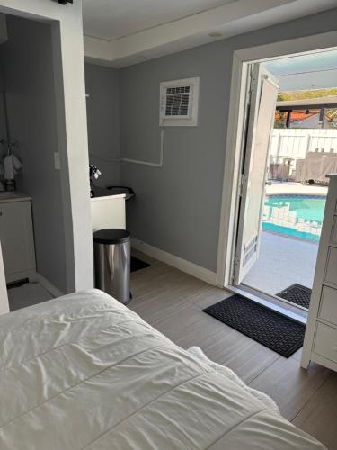 a bedroom with a bed and a swimming pool at Room in Miami
