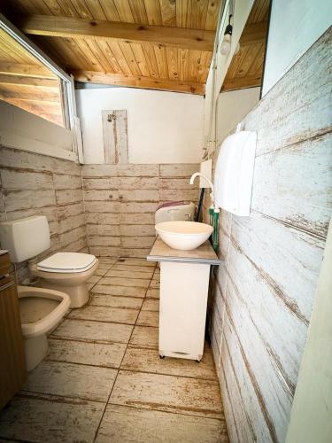a small bathroom with a toilet and a sink at Casa en playas del sur de mar del plata, la musa beach and home in San Eduardo del Mar