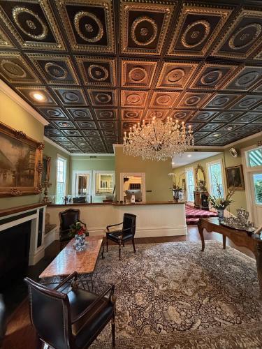 a living room with a coffered ceiling and a chandelier at Hotel St. Helena in St. Helena