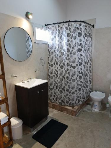 a bathroom with a sink and a shower curtain at Cabaña Zona Las Brusquitas in Miramar