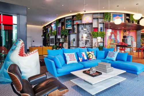 a living room with a blue couch and a table at citizenM Miami World Center in Miami