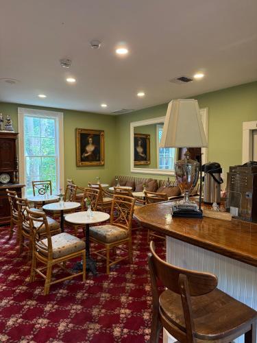 a restaurant with tables and chairs and a bar at Hotel St. Helena in St. Helena