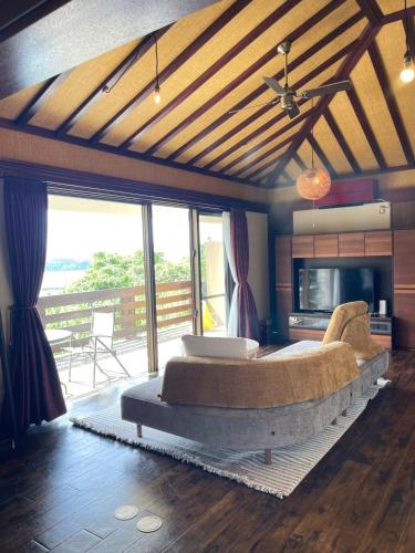 a bedroom with a large bed with a large couch at Kori Terrace N in Kouri