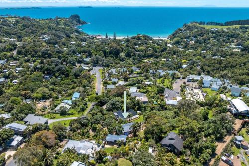 an aerial view of a suburb with houses and the ocean at Bay Haven - Walk to Palm Beach in Waiheke Island