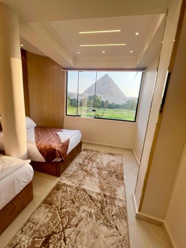 Ένα ή περισσότερα κρεβάτια σε δωμάτιο στο New Joia Pyramids Hotel