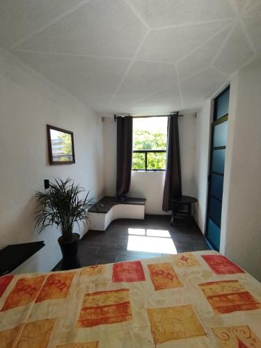 a bedroom with a large bed and a window at Palacio de los Angeles in San Felipe Hueyotlipan