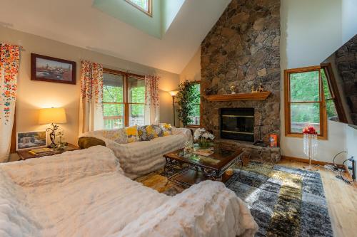 a living room with a couch and a fireplace at Leaf Peeper's - HUGE deck, pizza oven, Pac-man! in Davis