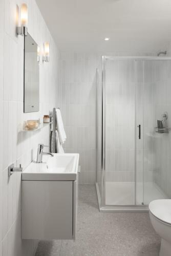 a bathroom with a shower and a sink and a toilet at Urban Rest Dublin Central in Dublin