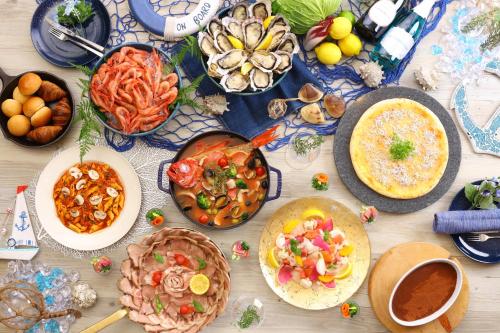 a table topped with plates of food and bowls of food at KAMENOI HOTEL Kujukuri in Asahi