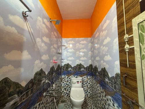 a bathroom with a wall mural of a toilet at DANDELI NAKADI Home Stay in Dandeli