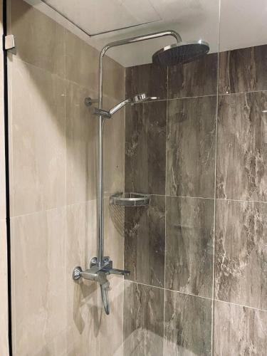 a shower in a bathroom with a glass door at The W Residence in Jakarta