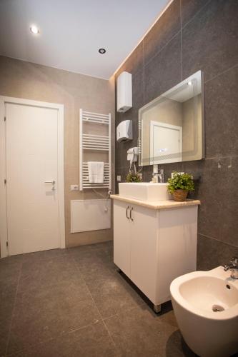 a bathroom with a sink and a mirror at Vila Claus Hotel in Tirana