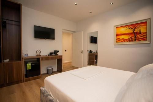 Ένα ή περισσότερα κρεβάτια σε δωμάτιο στο Vila Claus Hotel