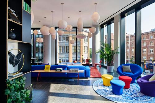 a lobby with blue furniture and large windows at citizenM Boston Back Bay in Boston