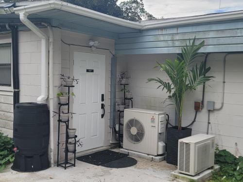 a front door of a house with a air conditioner at Twin Pines Studios in Jacksonville