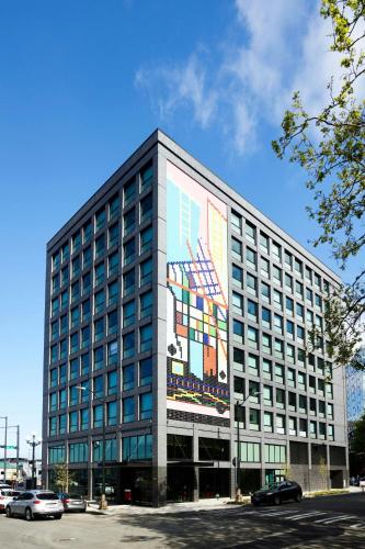 a building with a large mural on the side of it at citizenM Seattle Pioneer Square in Seattle