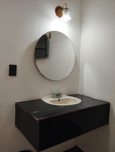 a bathroom with a sink and a mirror at Palacio de los Angeles in San Felipe Hueyotlipan