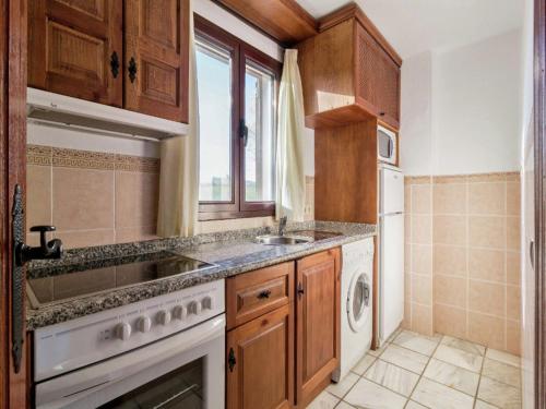 a kitchen with a sink and a dishwasher at Scenic Bungalow Retreat in Pozo Alcon in Cuenca
