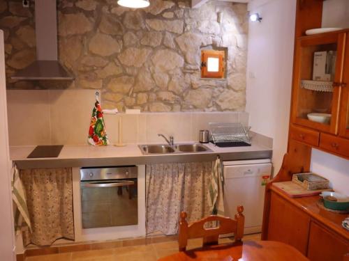a kitchen with a sink and a stove top oven at Detached rural 19th century country house in Calonge de Segarra