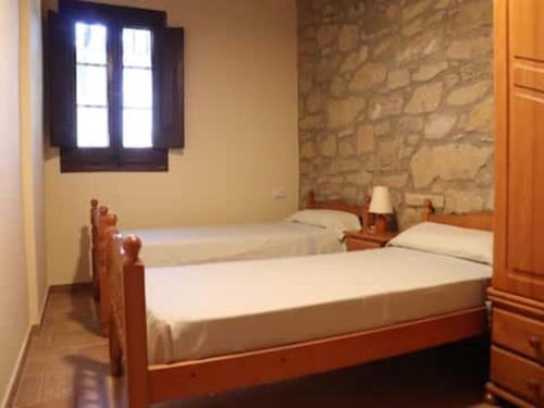 a bedroom with two beds and a window at Detached rural 19th century country house in Calonge de Segarra