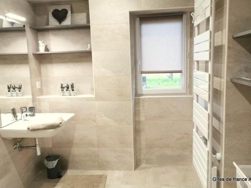 a white bathroom with a sink and a window at Gîte HUGO Domaine de la Pierre - FR-1-489-339 in Thiel-sur-Acolin