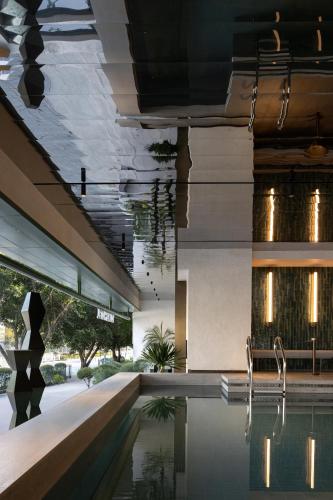 a building with a pool in the middle of it at YOUNG Hotel Guilin -Mixc Mall in Guilin