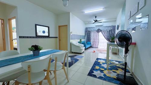 a kitchen with a table and chairs in a room at Sri Ixora Kajang Fully Air Con Suite in Kajang