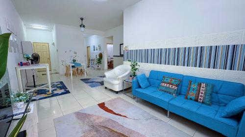 a living room with a blue couch and a chair at Sri Ixora Kajang Fully Air Con Suite in Kajang
