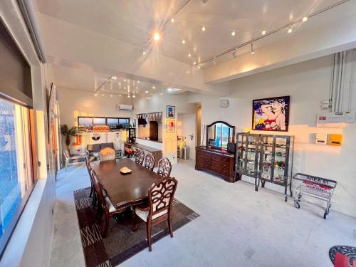 a dining room with a table and chairs at SEA BASE Onna in Onna